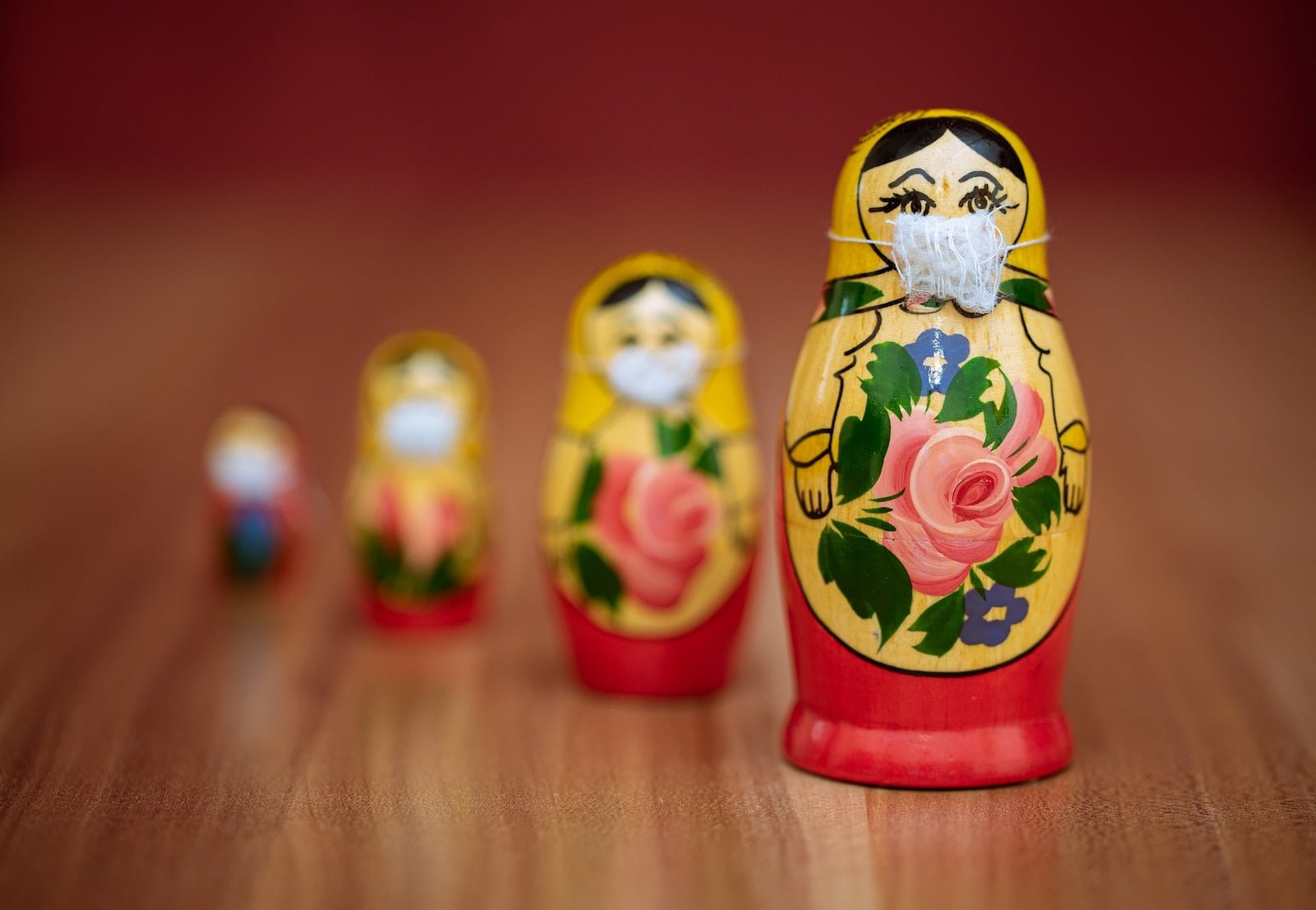 two yellow and red ceramic owl figurines